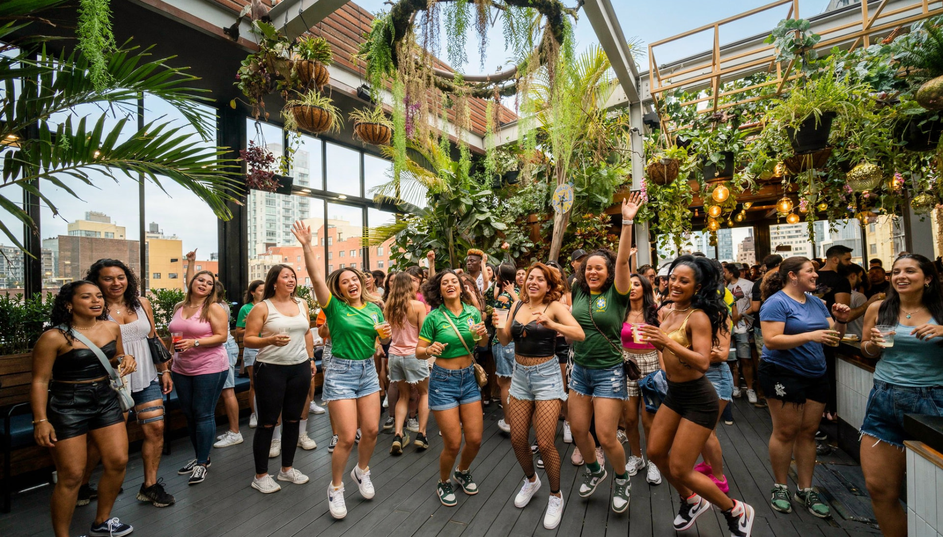 Friends dancing at a Baile de Favela rooftop day party in New York